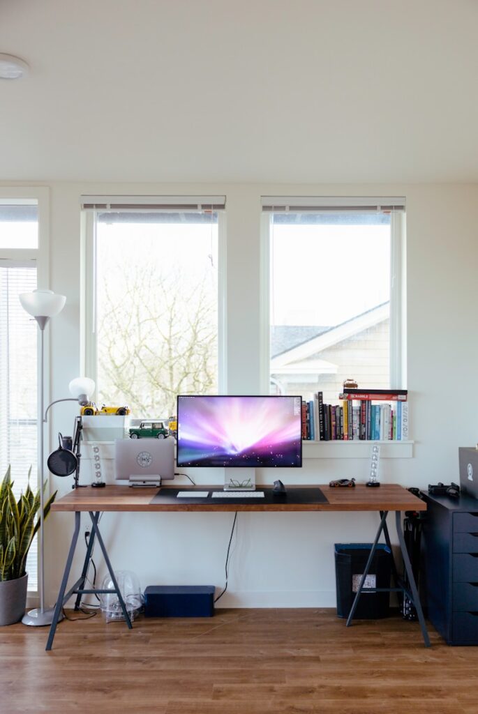 black flat screen tv on brown wooden table