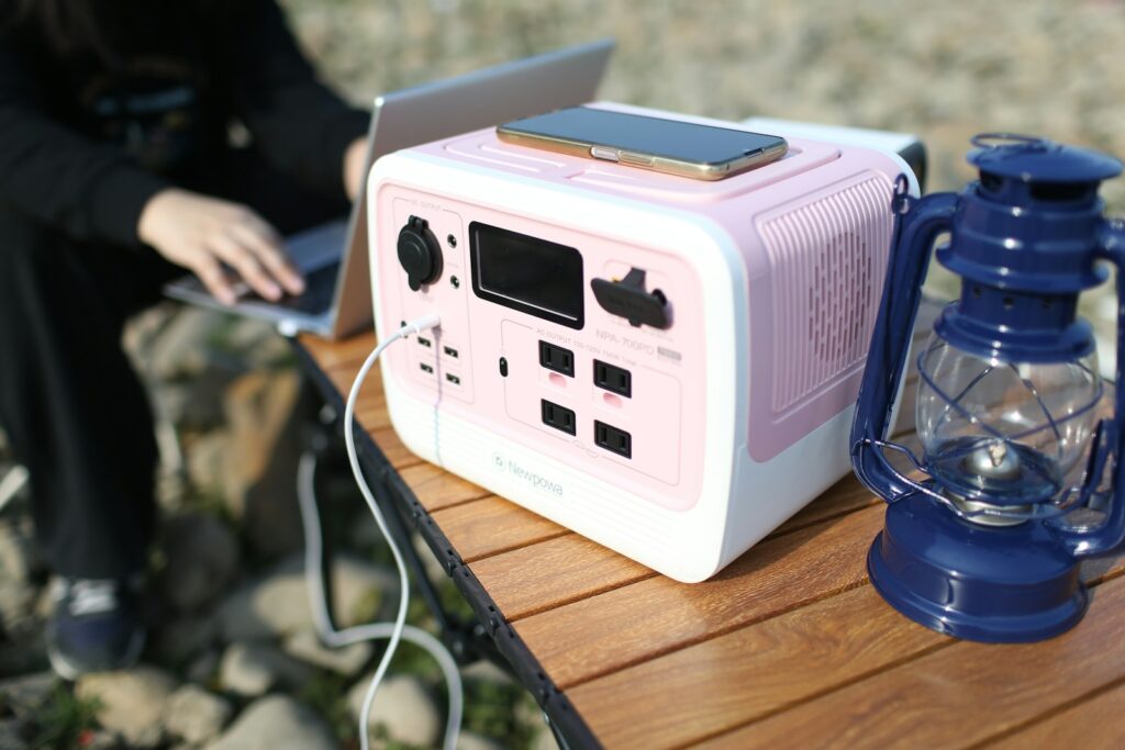 a white electronic device with a blue light on a wooden surface